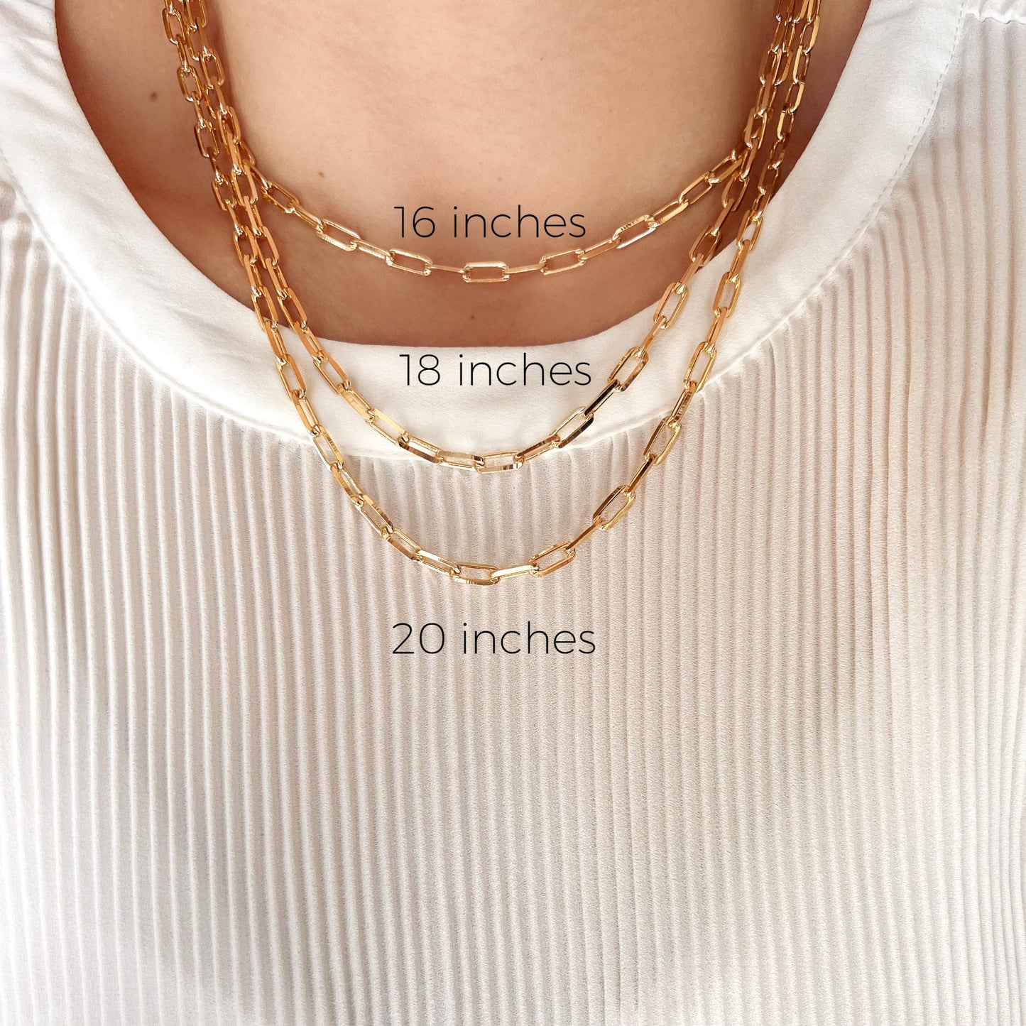 woman wearing three gold chain necklaces