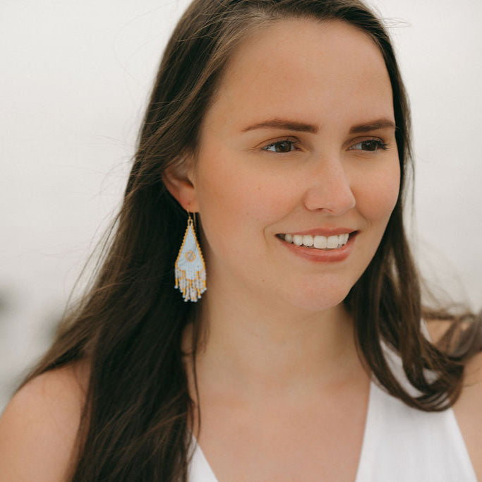 Woman smiling and wearing beaded earrings