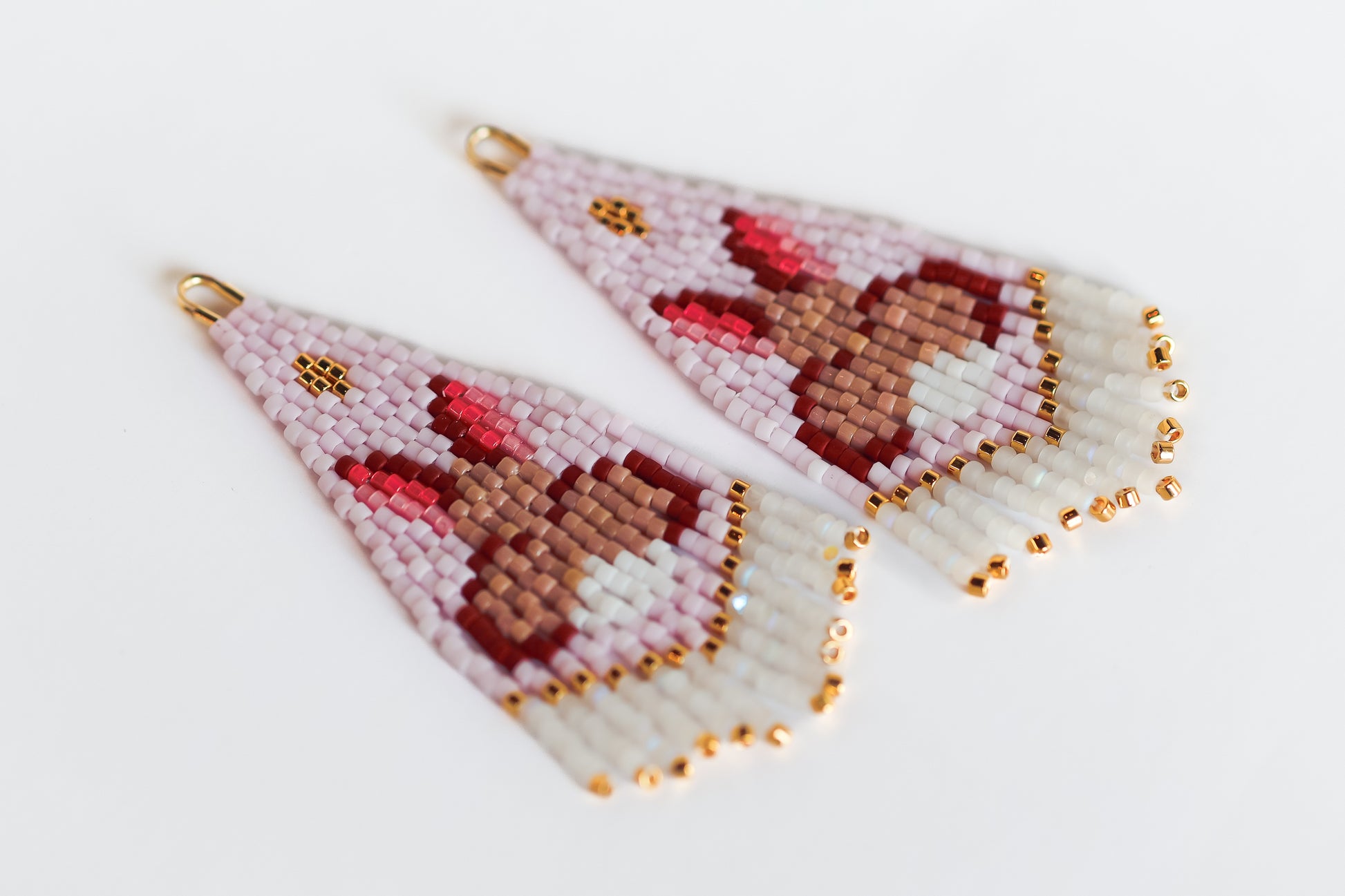 Beaded earrings with a bunny design on a light background