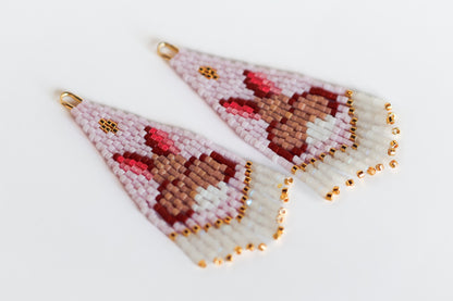 Beaded earrings with a bunny design on a light background
