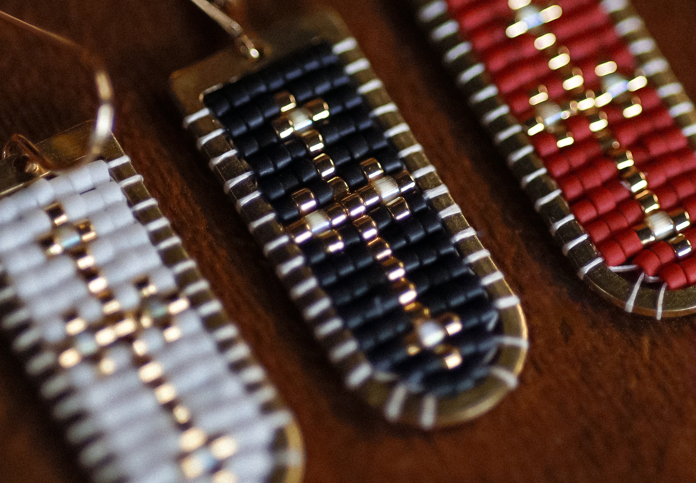 Close-up of beaded earrings on a wooden surface