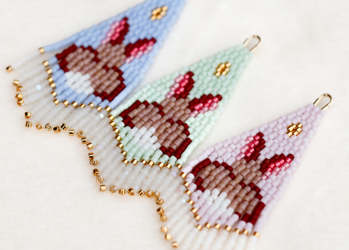 Beaded earrings with rabbit design on a light background