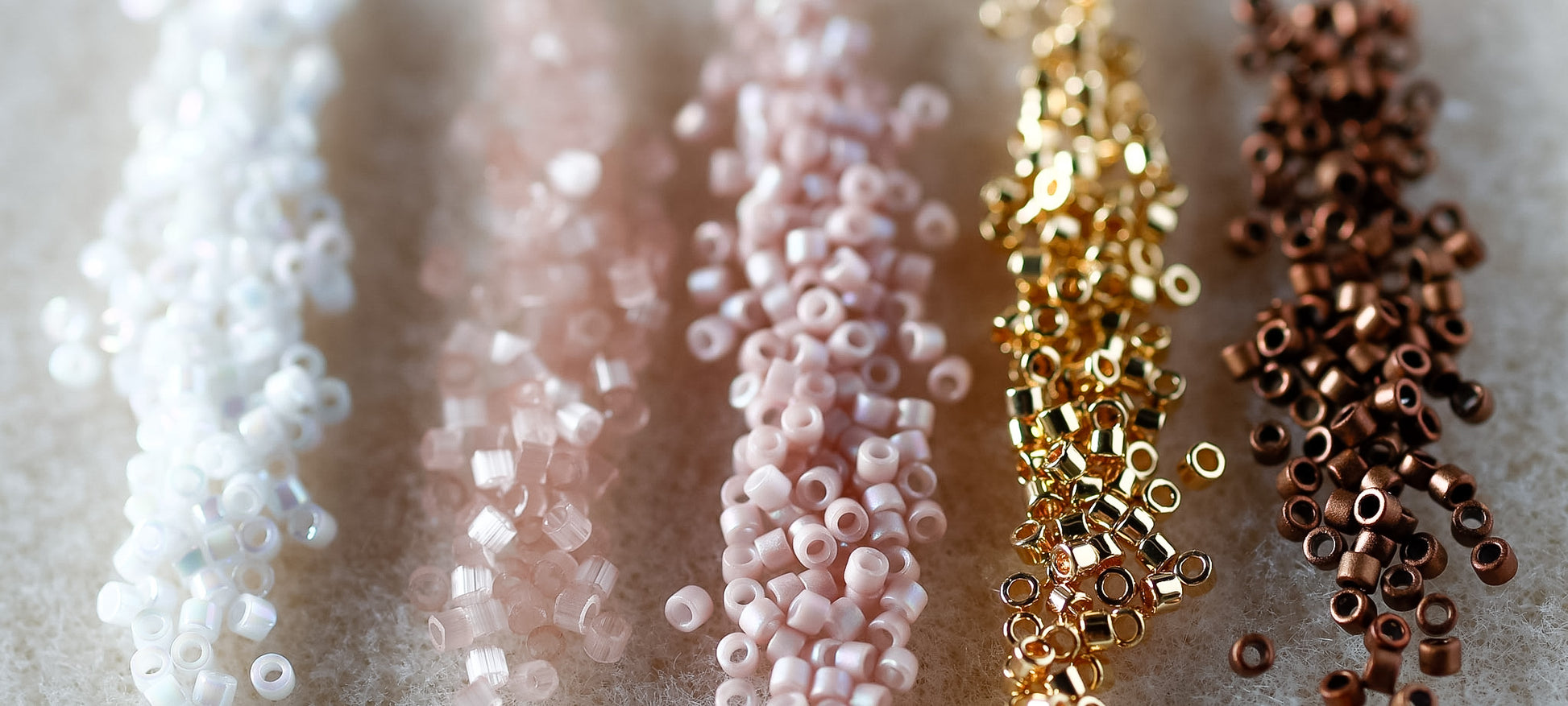 Close-up of various colored beads on a textured surface