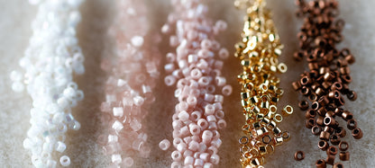 Close-up of various colored beads on a textured surface