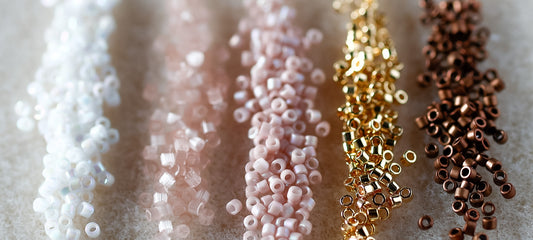 Close-up of various colored beads on a textured surface