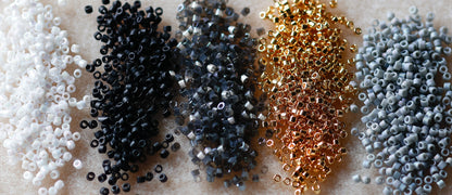 Collection of small beads in various colors on a textured surface