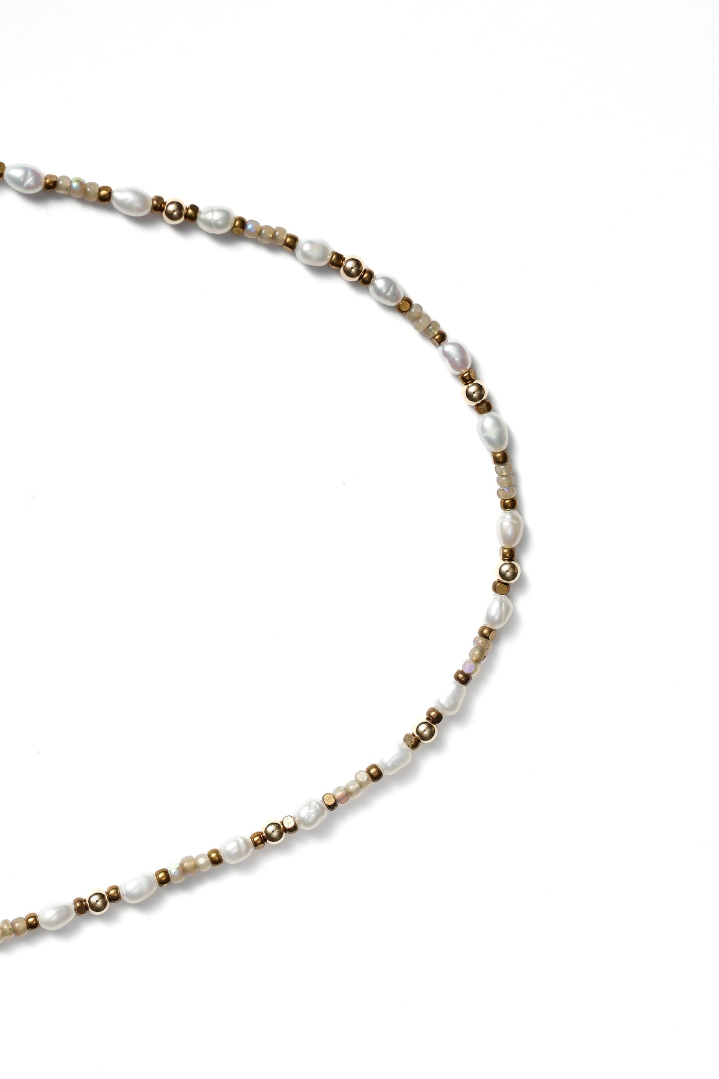 Closeup of a beaded necklace on a white background