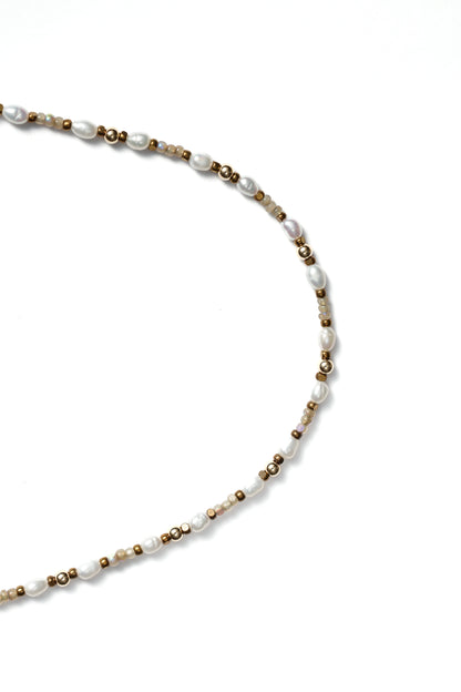 Closeup of a beaded necklace on a white background