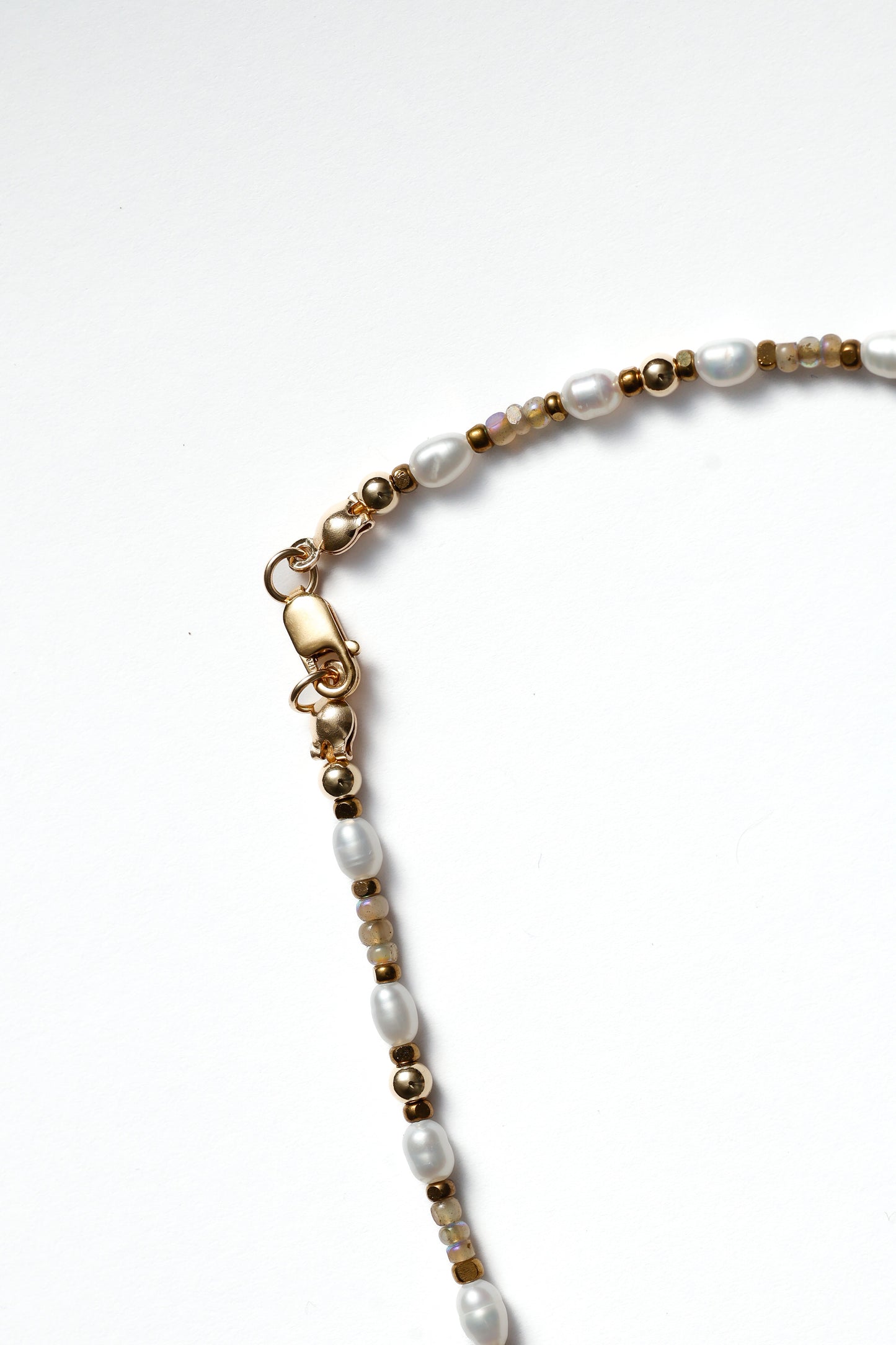 Necklace with pearls and gold accents on a white background