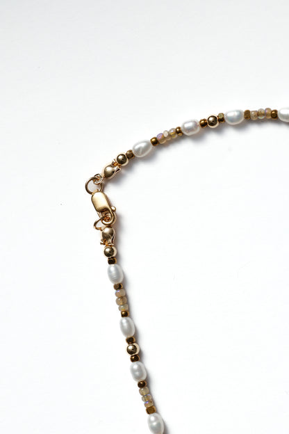 Necklace with pearls and gold accents on a white background
