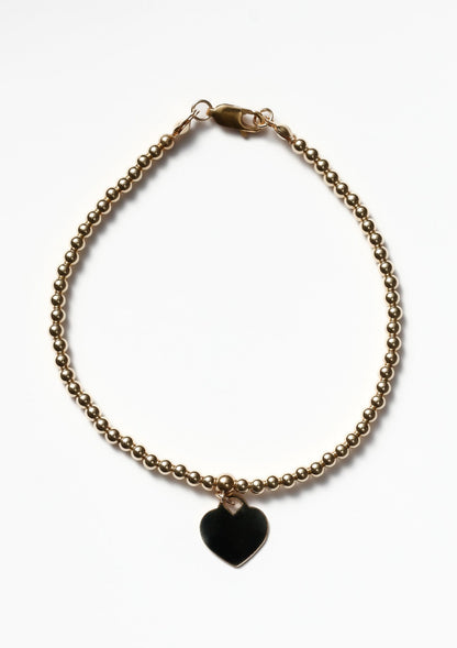 Gold bracelet with a heart pendant 