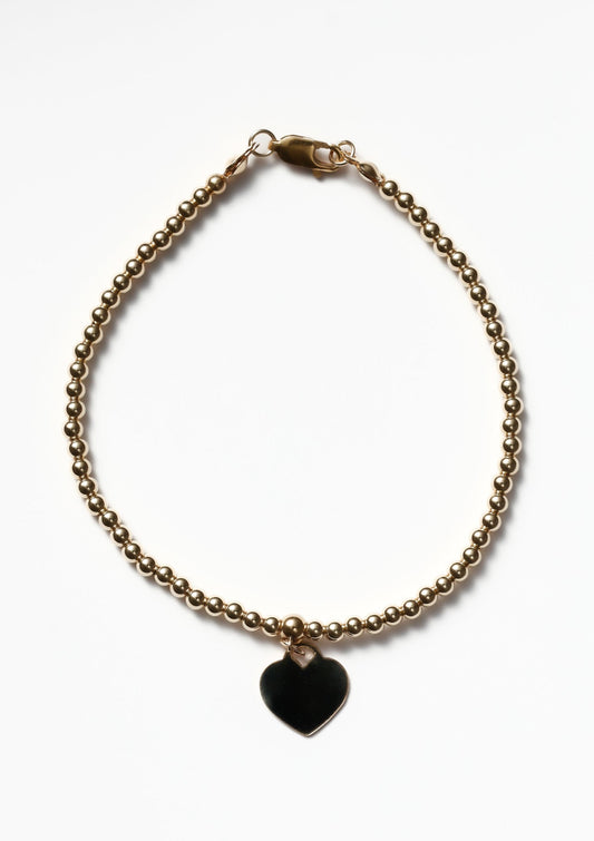 Gold bracelet with a heart pendant 