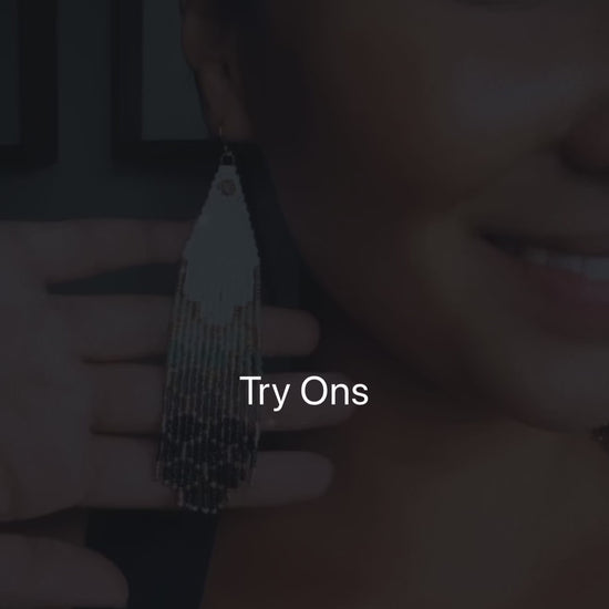 Woman wearing beaded earrings, showcasing them in a try-on