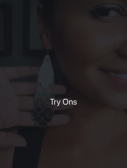 Woman wearing beaded earrings, showcasing them in a try-on